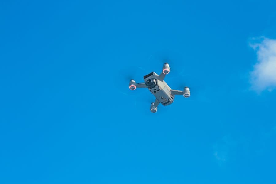 Illustration: a camera drone flying against a blue sky