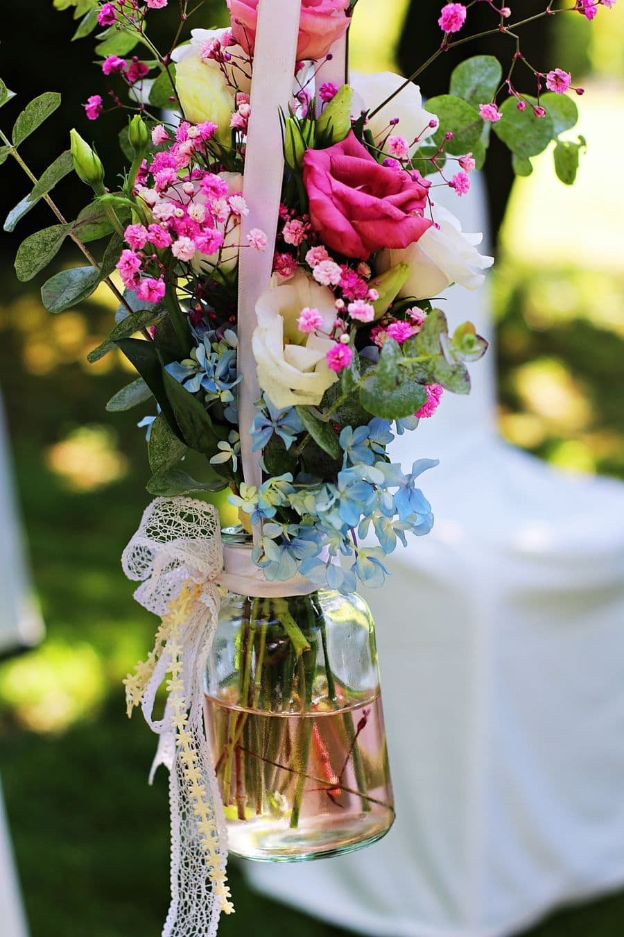 Illustration: pink and blue flowers in a hanging glass vase